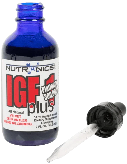 A blue glass bottle labeled IGF1 Plus Platinum 300,000 sits upright on a white background. The label has the brand name "NUTRONICS" at the top and mentions "All Natural Velvet Deer Antler" along with a dosage of "300,000 NG/300MCG." The bottle is accompanied by a black dropper cap with a clear pipette attached, positioned next to the bottle. The overall appearance suggests it is a dietary supplement with an emphasis on anti-aging properties.