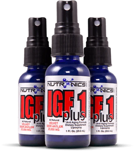 Three blue spray bottles of a dietary supplement labeled IGF 1 plus are arranged closely together. Each bottle has a black spray nozzle and a white label that reads "NUTRONICS IGF 1 plus All Natural VELVET DEER ANTLER 25,000 NG" along with "1 FL. OZ. (29.6 mL)". The bottles are designed for anti-aging purposes and the overall look is sleek and modern.